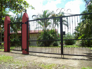 The property has a handsome gate and wrought iron fence.